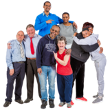 A group of friends hugging each other and looking happy.