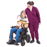 A mother in a wheelchair with her daughter standing next to her.